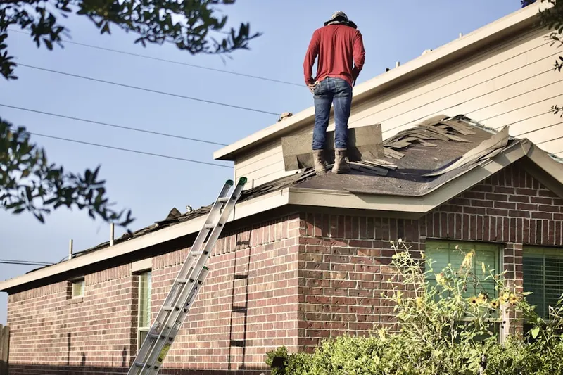 Professional roofer working on a residential roof in Springs Ranch